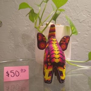 This is a wooden elephant with beads